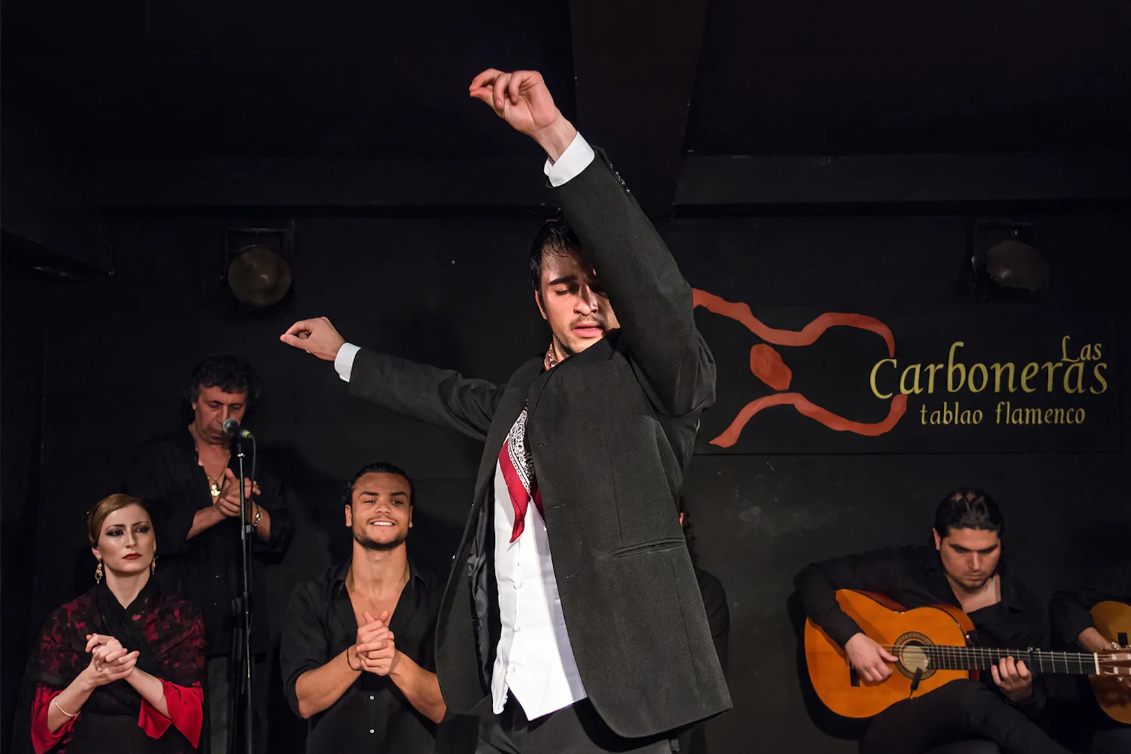 Flamenco dancer performing at Tablao Las Carboneras with musicians in Madrid.