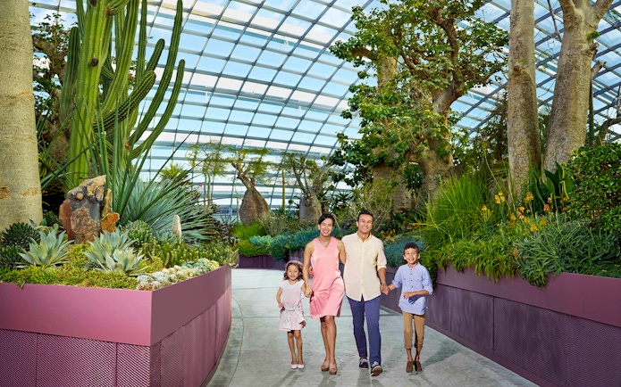 Family walking through Gardens by the Bay conservatory in Singapore.