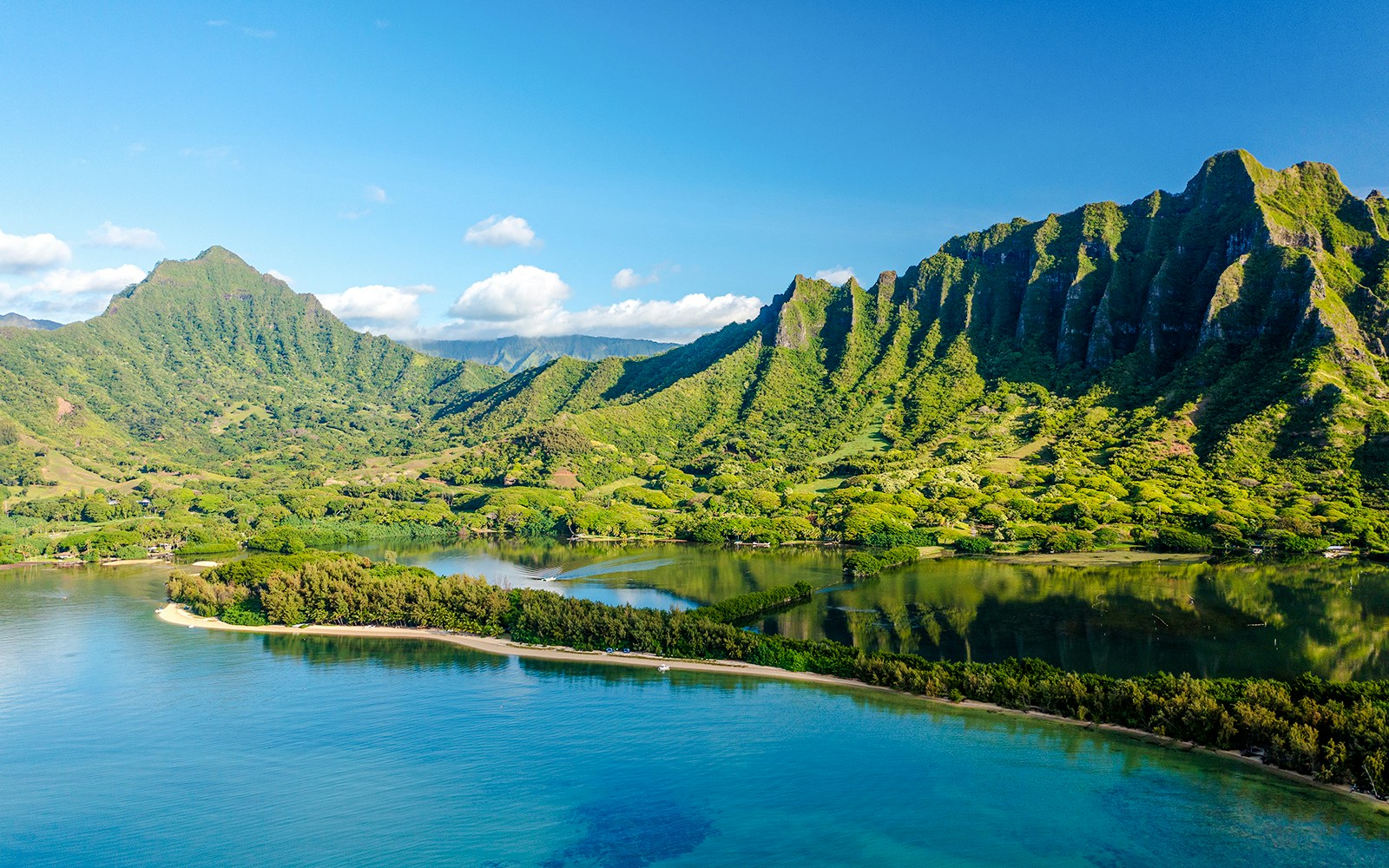 Kualoa Ranch landscape with lush green mountains and coastal waters, Oahu, Hawaii.