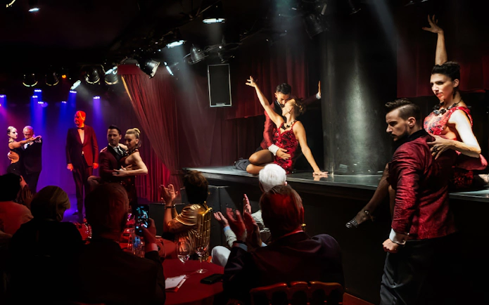 Dancers performing at Rojo Tango Show in Buenos Aires with audience watching.