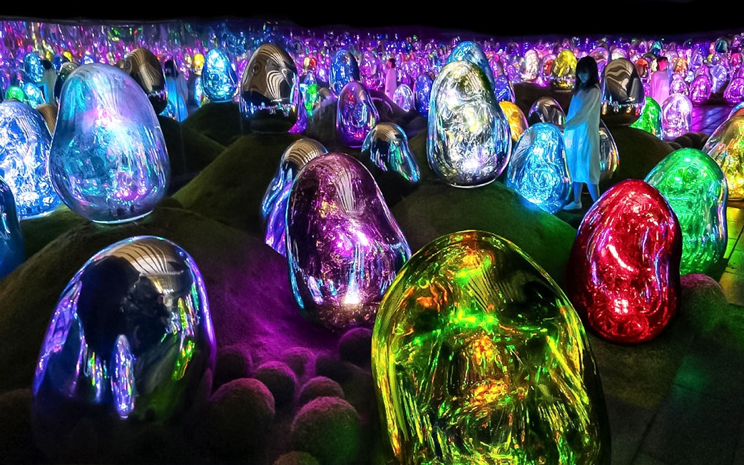 Colorful digital art installations at TeamLab Planets Tokyo with illuminated sculptures.