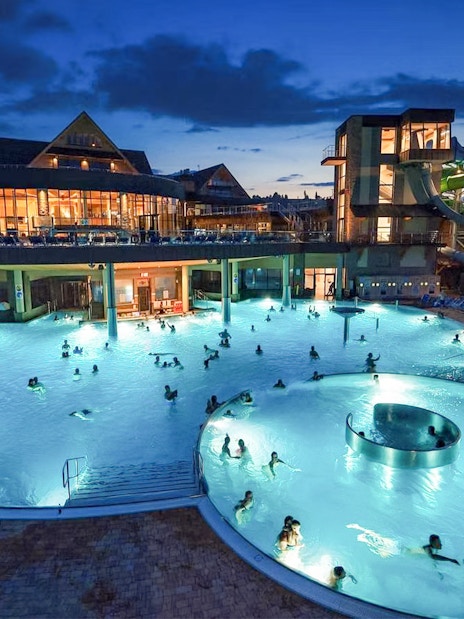 Thermal pools at night with people swimming, Zakopane tour experience.