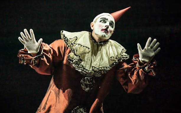 Performer in clown costume during a cabaret show.
