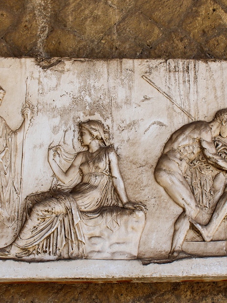 Bas-relief depicting ancient figures in Herculanum, Italy.
