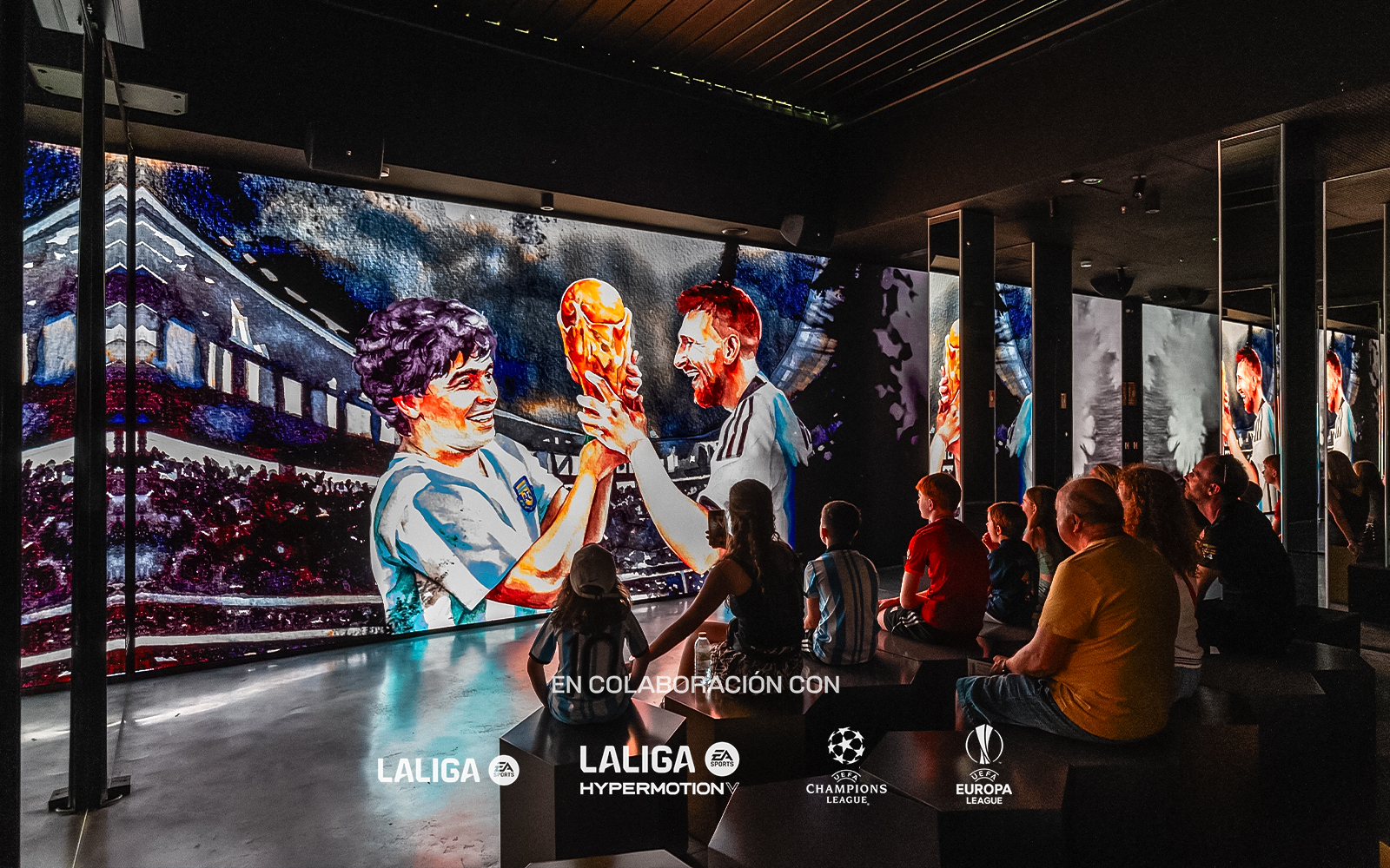 Visitors watching a football-themed digital display at Legends: The Home of Football Museum.