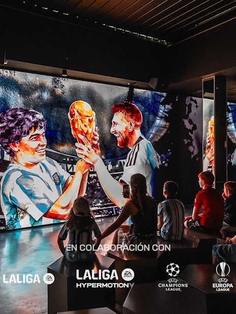Visitors watching a football-themed digital display at Legends: The Home of Football Museum.