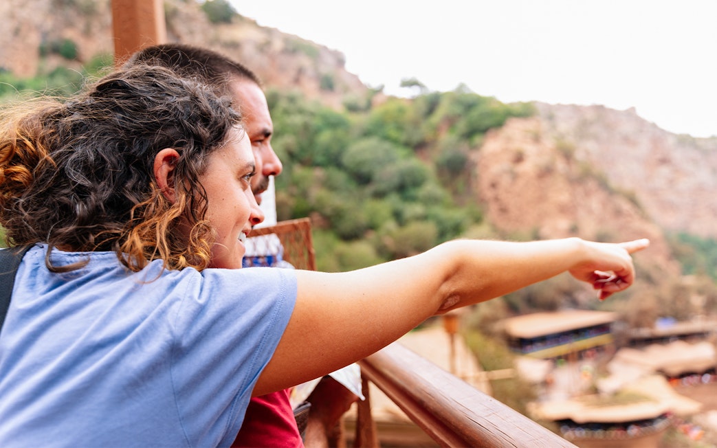 Guide pointing out Ouzoud Falls to tourist, Marrakesh.