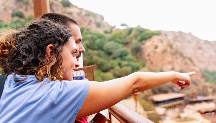 Guide pointing out Ouzoud Falls to tourist, Marrakesh.