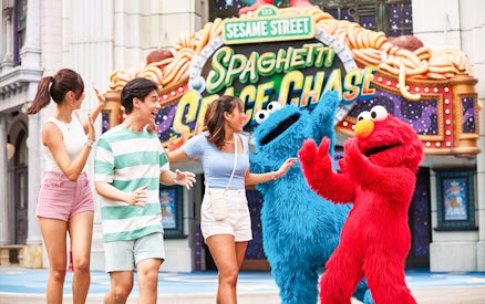 Visitors interacting with Sesame Street characters at Universal Studios Singapore.