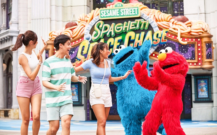 Visitors interacting with Sesame Street characters at Universal Studios Singapore.