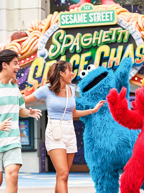 Visitors interacting with Sesame Street characters at Universal Studios Singapore.