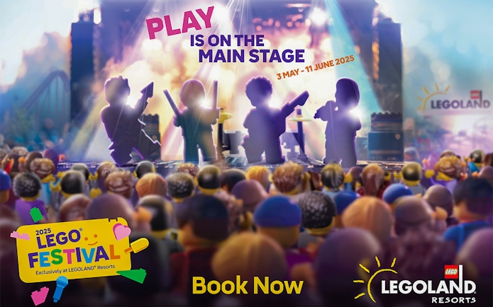 LEGO figures performing on stage at LEGOLAND Windsor Resort festival event.