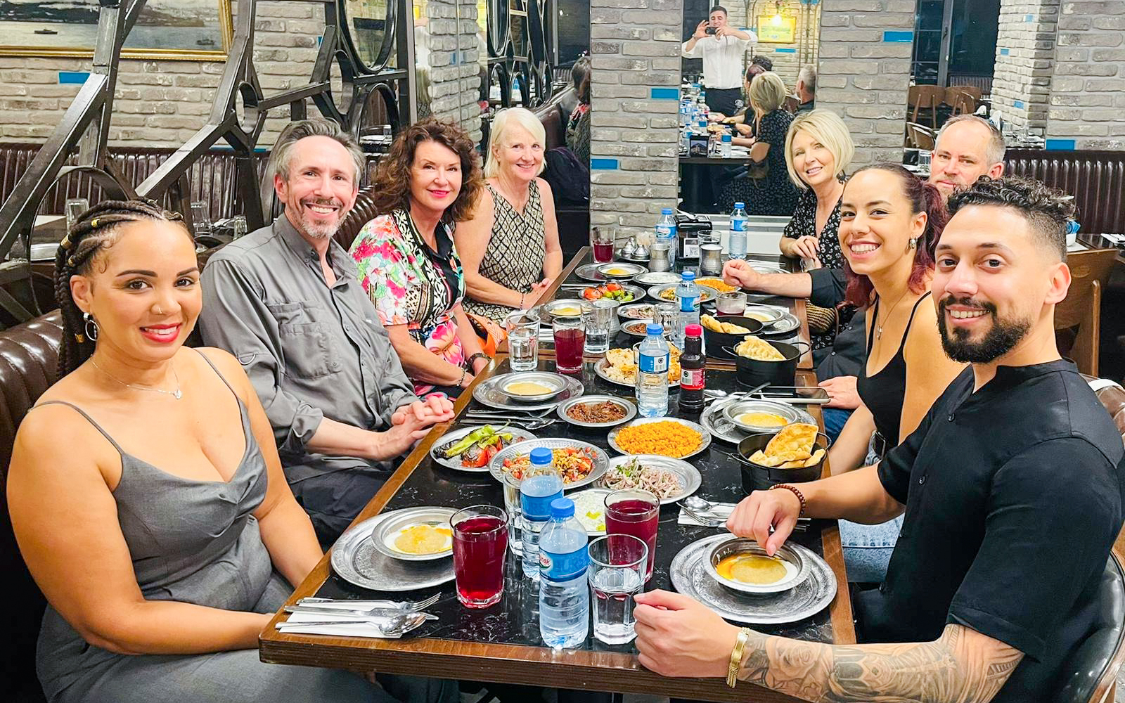 Group enjoying Turkish cuisine at a rooftop restaurant in Istanbul.