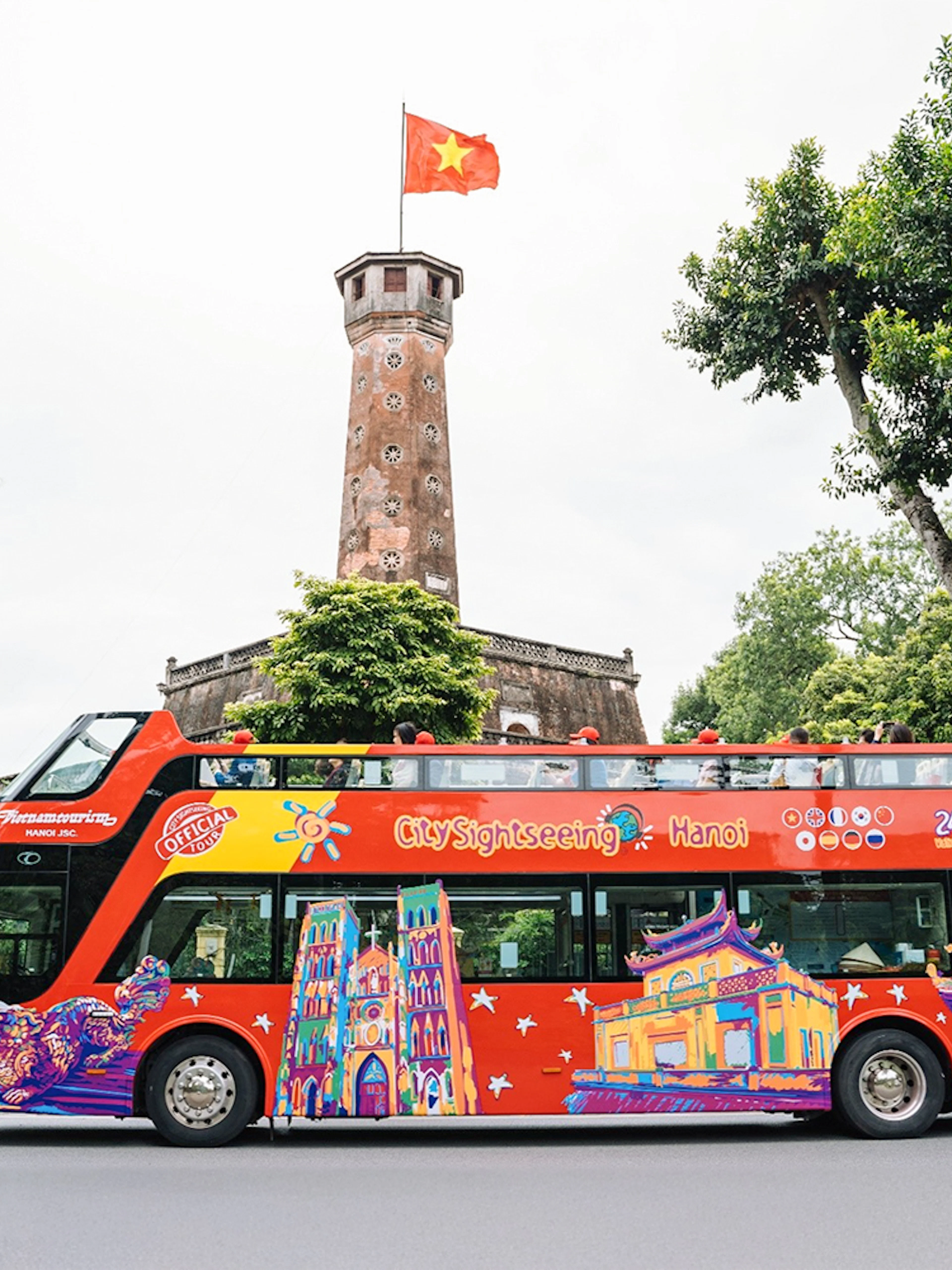 City Sightseeing hop on hop off bus in front of Hanoi Flag Tower.