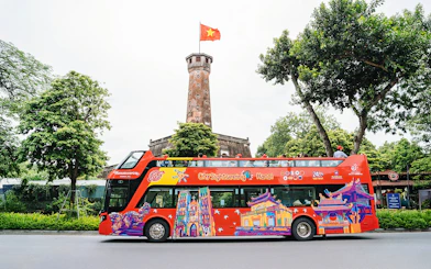 City Sightseeing hop on hop off bus in front of Hanoi Flag Tower.