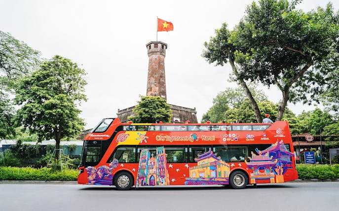 City Sightseeing hop on hop off bus in front of Hanoi Flag Tower.