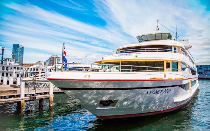Cruise ship Sydney 2000 docked at Sydney Harbour with city skyline.
