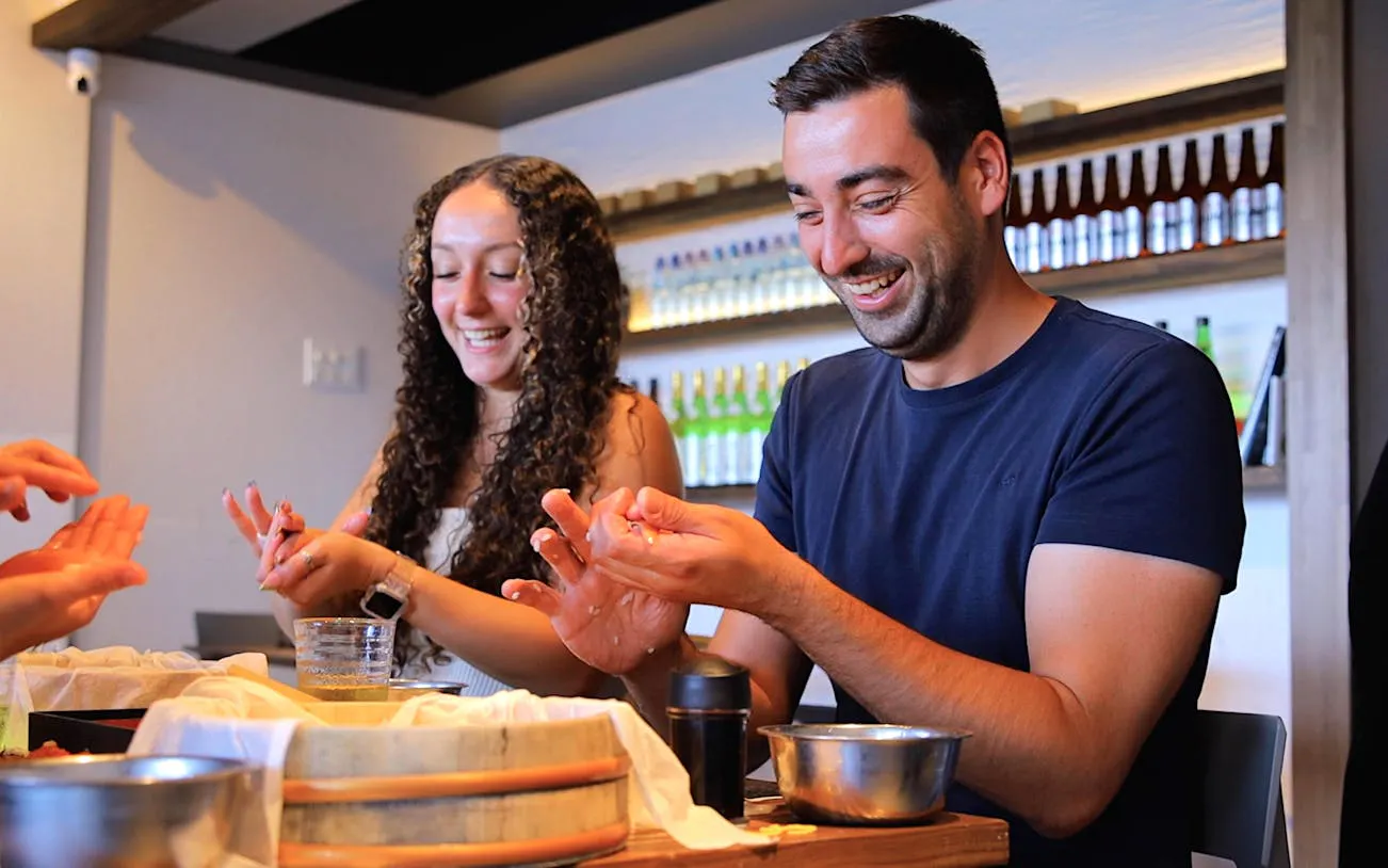Participants enjoying a sushi-making class in Asakusa, Tokyo.