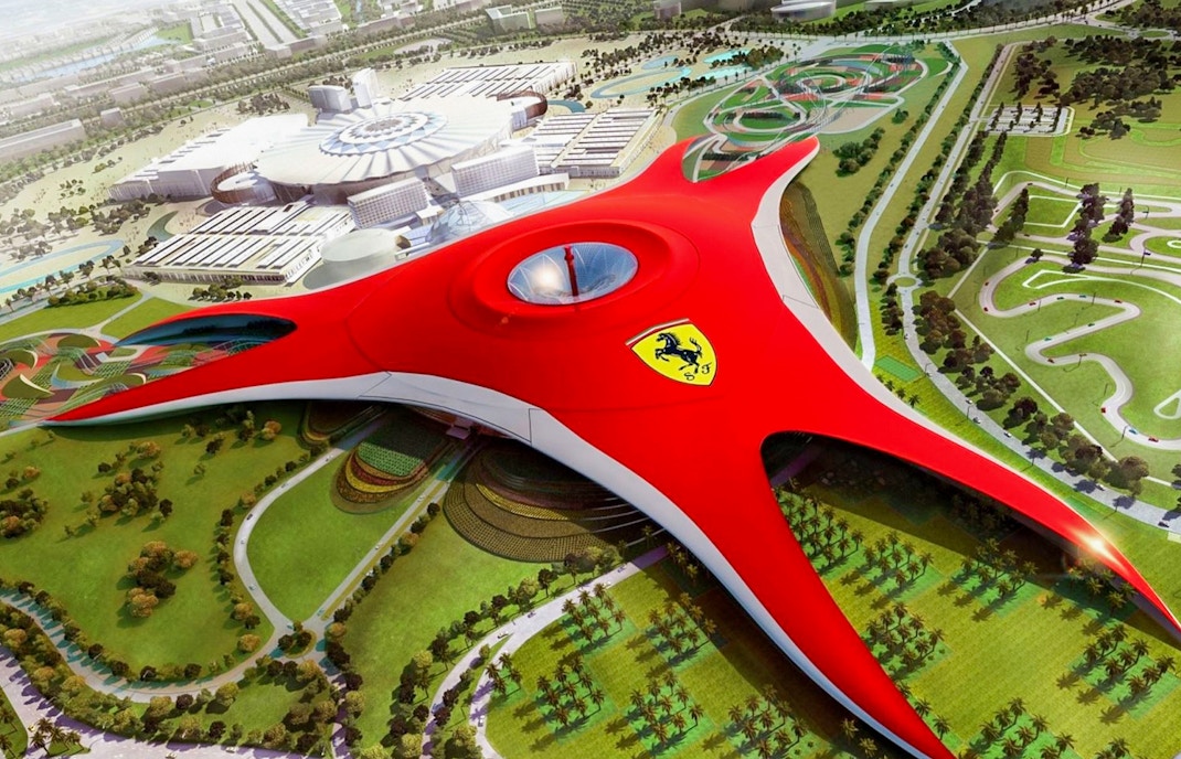 Ferrari World Abu Dhabi aerial view with iconic red roof and surrounding attractions.