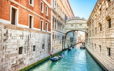 Gondolas on a canal under the Bridge of Sighs in Venice, Italy.