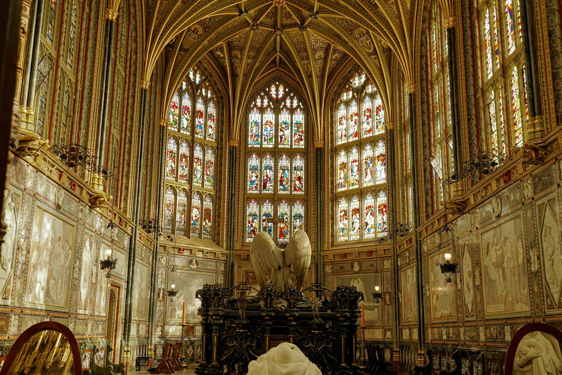 Stained glass windows and ornate ceiling in St. George's Chapel nave.