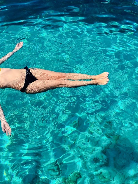 Guest floating in clear water during Blue Lagoon, Ciovo & Trogir Speedboat Tour.