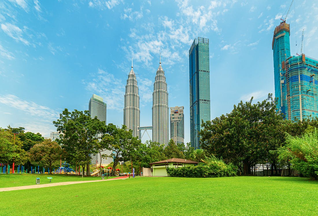 KLCC Park with Petronas Twin Towers in Kuala Lumpur, Malaysia, skyline view.