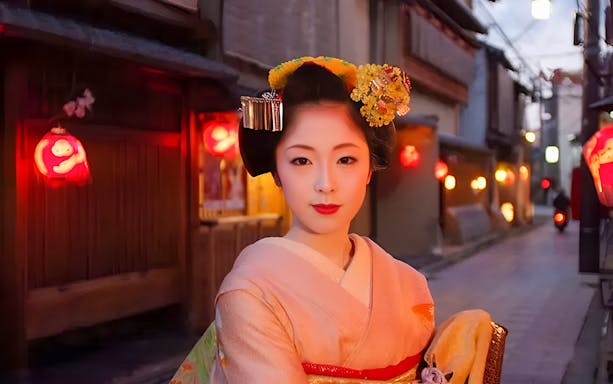 Geisha in traditional attire on a lantern-lit street in Kyoto, Japan.