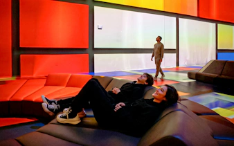Visitors relaxing in the colorful light installation at Mercer Labs Museum of Art.