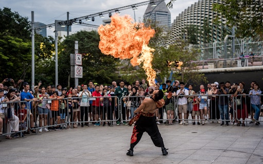 Firebreather performing for a crowd at Singapore F1 event.