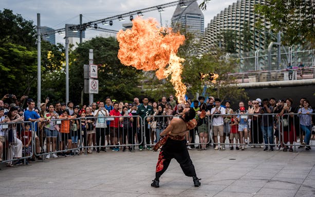 Firebreather performing for a crowd at Singapore F1 event.