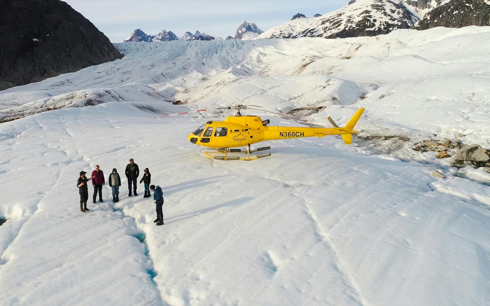 Helicopter on glacier with tourists during Juneau tour, Alaska.