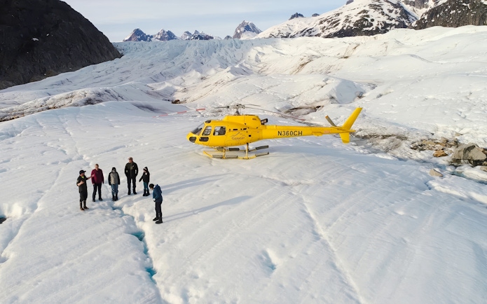 Helicopter on glacier with tourists during Juneau tour, Alaska.