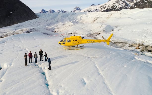 Helicopter on glacier with tourists during Juneau tour, Alaska.
