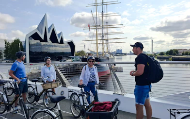 Guests on bikes near the Riverside Museum and Tall Ship in Glasgow.