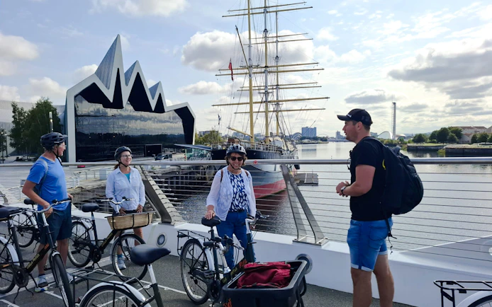 Guests on bikes near the Riverside Museum and Tall Ship in Glasgow.