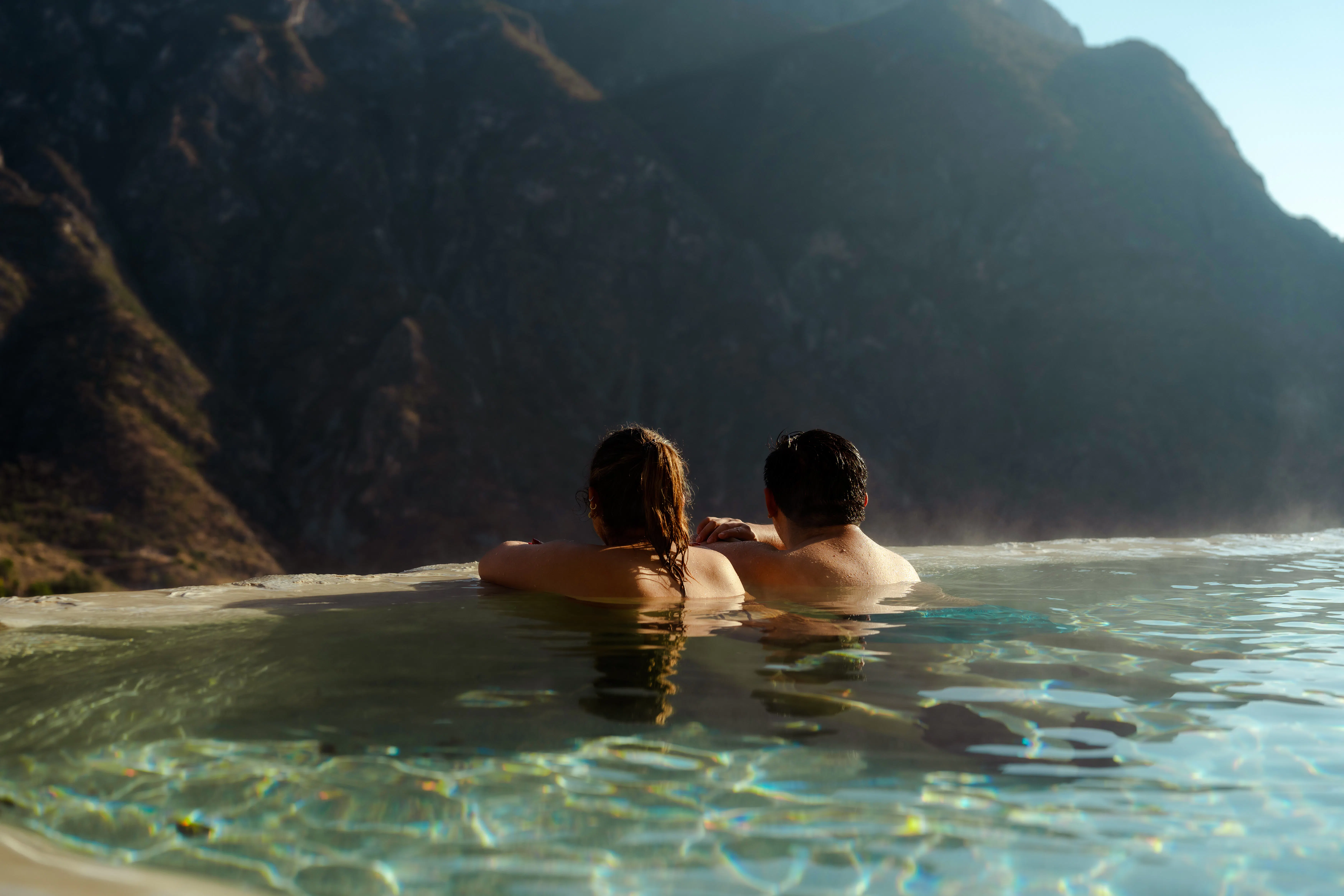 Couple relaxing in Tolantongo hot springs with mountain view, Mexico.