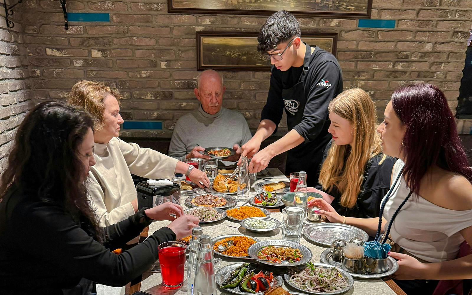 Guests dining at a Turkish restaurant in Istanbul, enjoying traditional dishes.