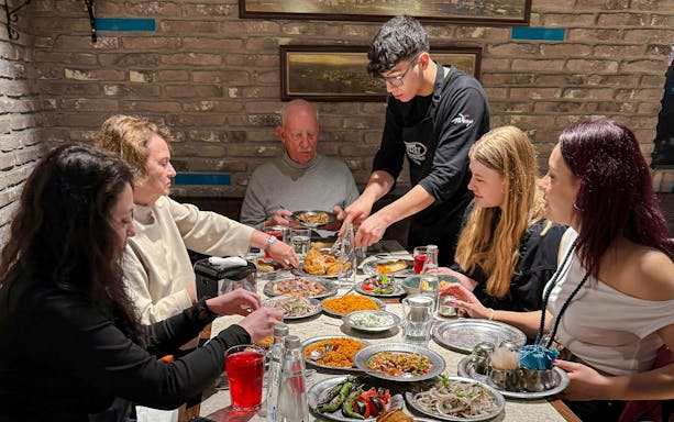 Guests dining at a Turkish restaurant in Istanbul, enjoying traditional dishes.