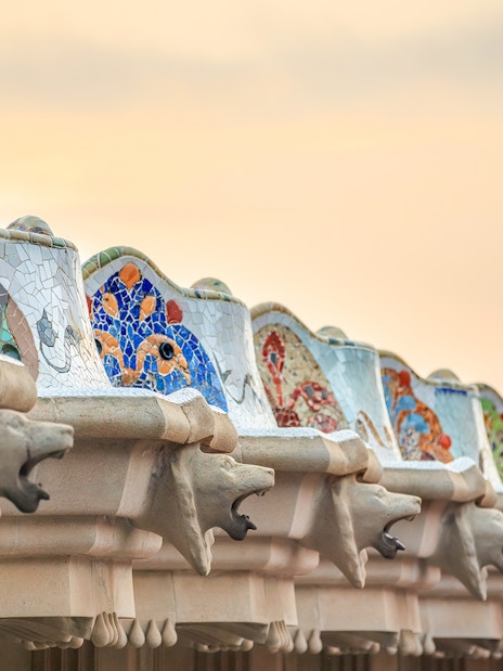Mosaic benches and sculptures at Park Güell, Barcelona, during a guided tour.