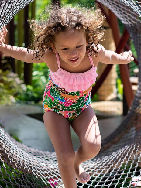 Child playing in net tunnel at Siam Park, Tenerife.