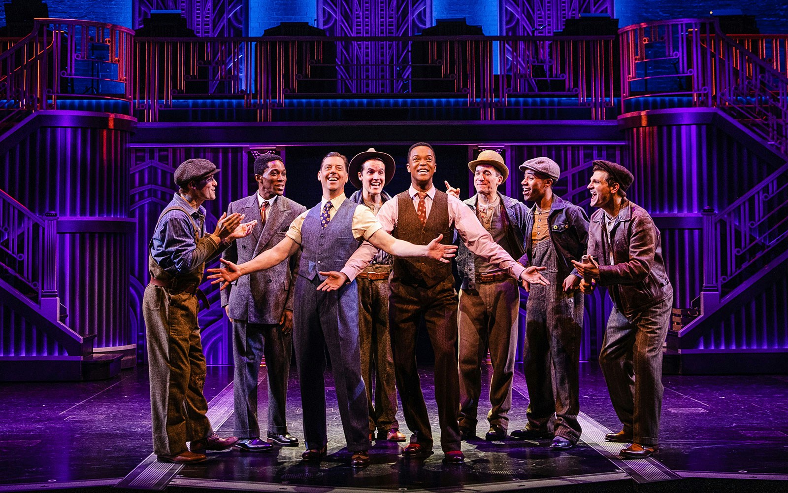 Musical cast performing "Some Like it Hot" on stage with vibrant lighting.