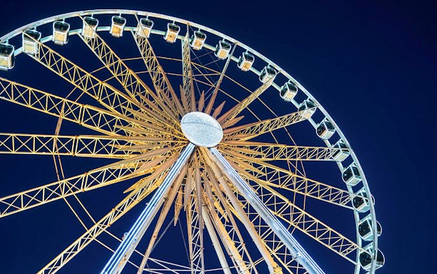 Niagara SkyWheel illuminated against night sky, offering panoramic views.
