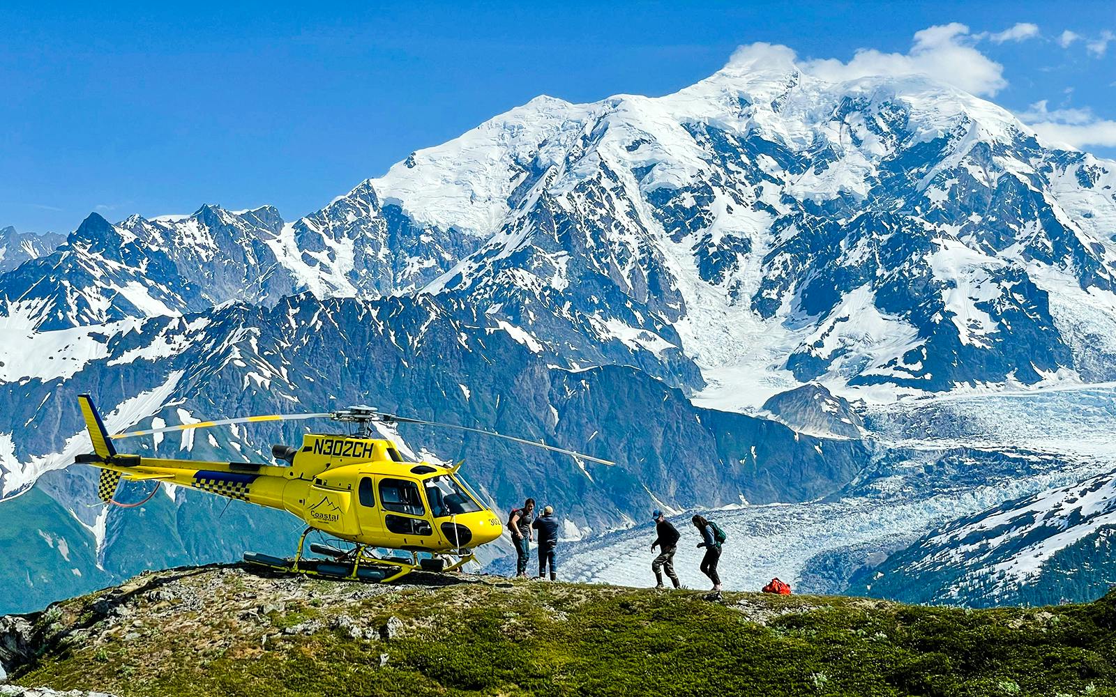 Helicopter on a glacier with tourists in Juneau, Alaska, during a dog sledding tour.