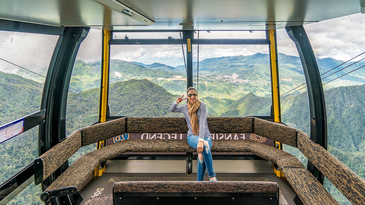 Visitor enjoying view inside Fansipan Cable Car at Sun World Fansipan Legend, Vietnam.
