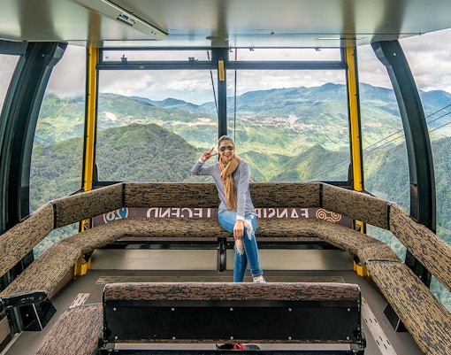 Visitor enjoying view inside Fansipan Cable Car at Sun World Fansipan Legend, Vietnam.