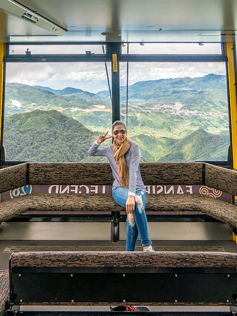 Visitor enjoying view inside Fansipan Cable Car at Sun World Fansipan Legend, Vietnam.