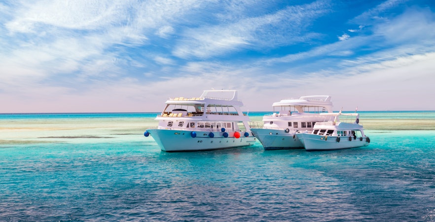 Cruise yachts on clear water near coral reef, Hurghada Sea trip.