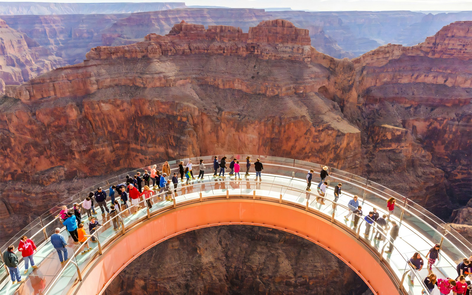Grand Canyon Skywalk with tourists overlooking the canyon, part of the Grand Canyon West and Hoover Dam bus tour.