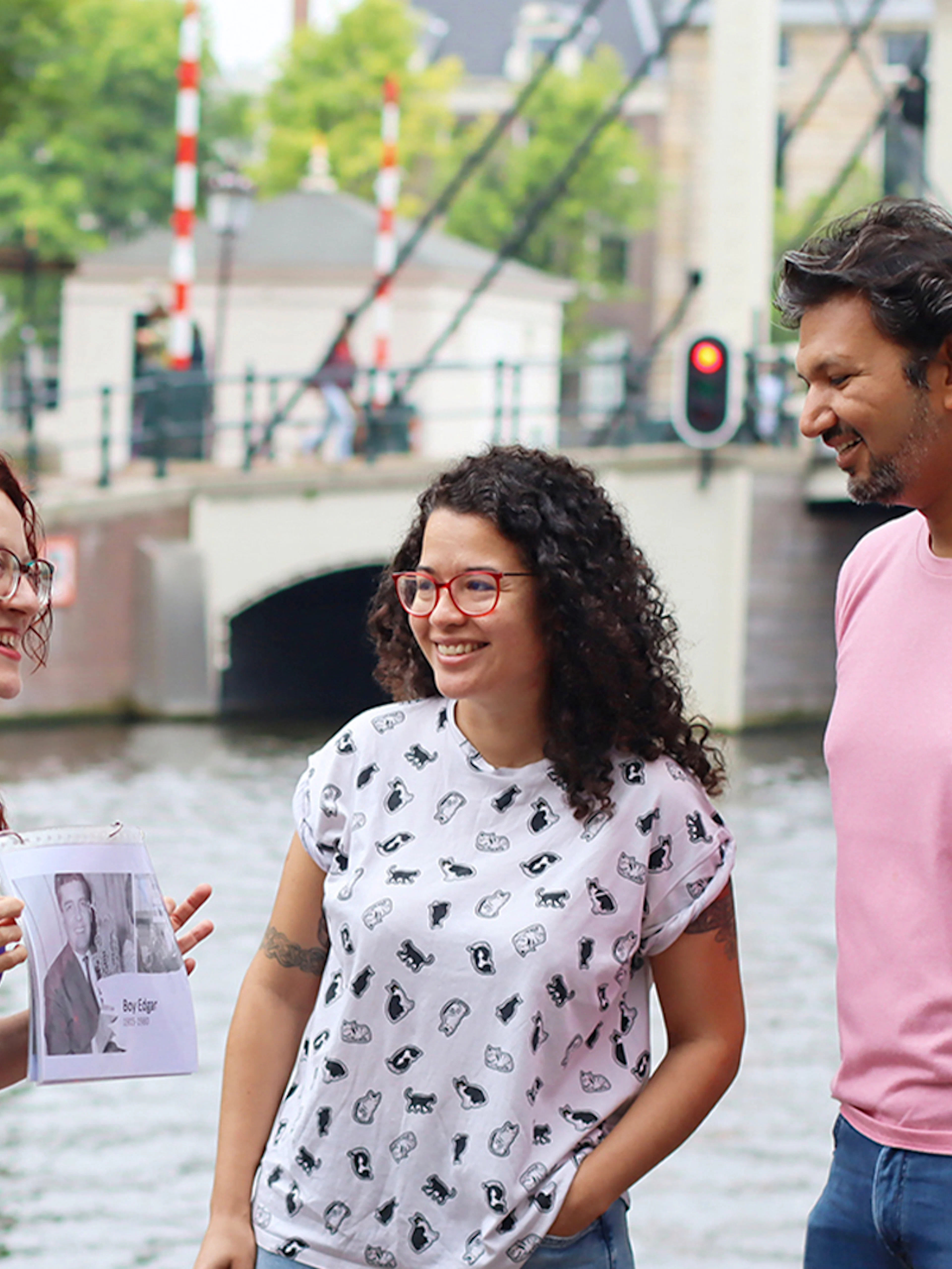 Tour guide with a group by a canal in Amsterdam on a SmallGroup Hidden Gems Tour.